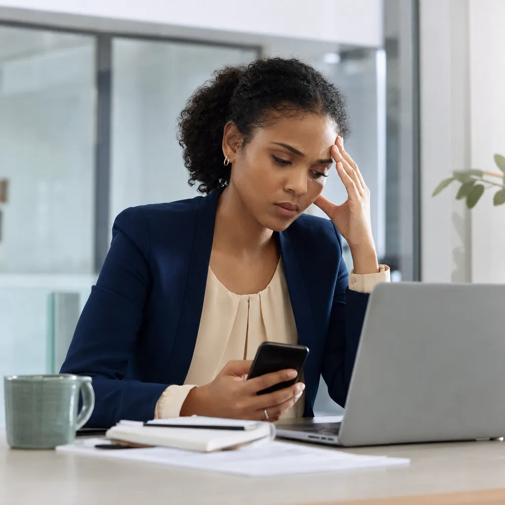 Creator at her desk checking her phone