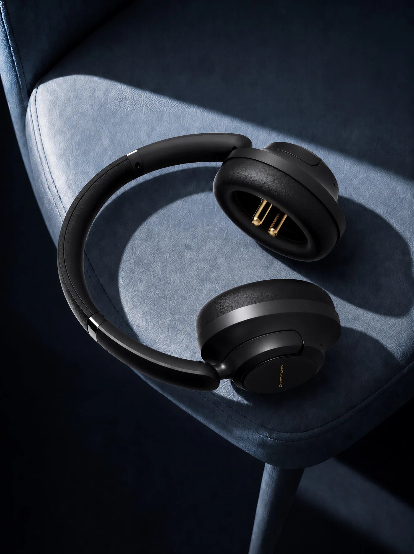 Obsidian Black DreamPhones resting on a blue chair